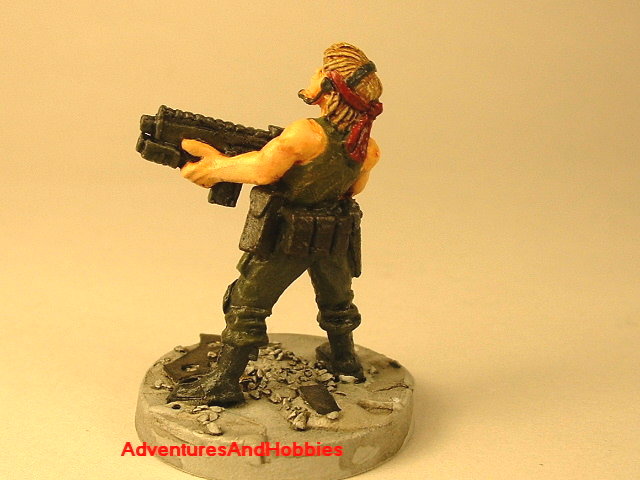 Post apocalypse female soldier with assault rifle and grenade launcher 25 mm painted figure for role-playing games and table top war games rear view