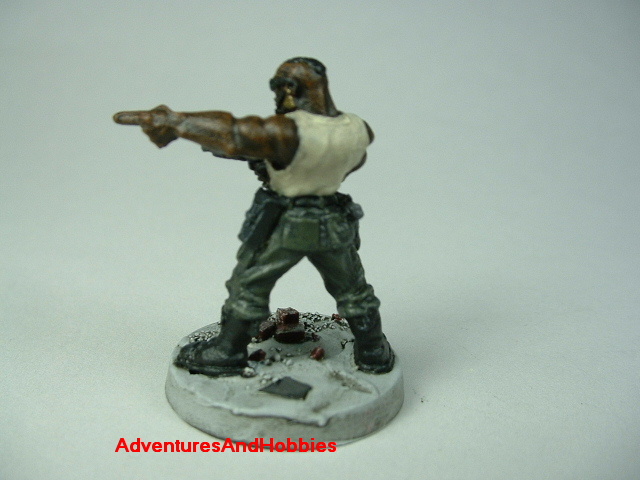 Post apocalypse soldier zombie hunter with submachinegun painted figure for role-playing games and table top war games - rear view