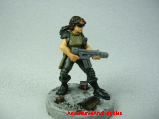 Post apocalypse female soldier zombie hunter with miltary assault rifle painted figure for role-playing games and table top war games - front view