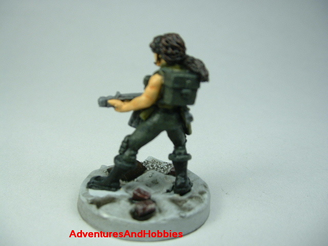 Post apocalypse female soldier zombie hunter with miltary assault rifle painted figure for role-playing games and table top war games - rear view