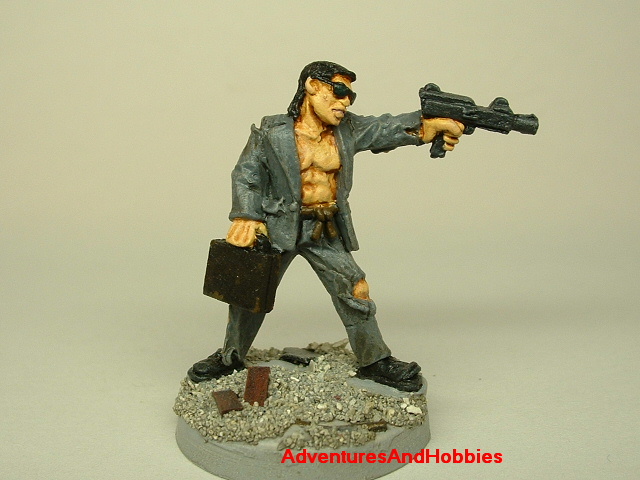 Post apocalypse survivor in ragged suit and machine gun painted figure for role-playing games and table top war games front view