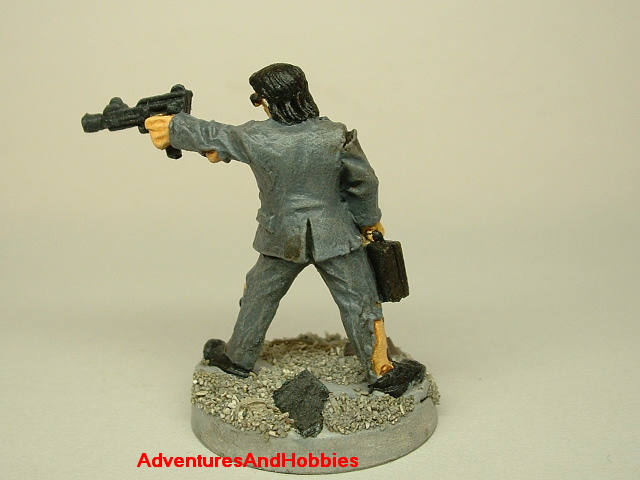 Post apocalypse survivor in ragged suit and machine gun painted figure for role-playing games and table top war games rear view