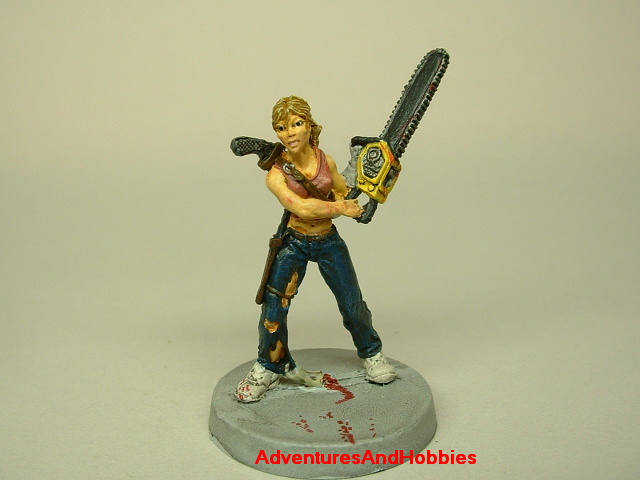 Zombie survivor woman with chainsaw painted figure for role-playing games and table top war games front view