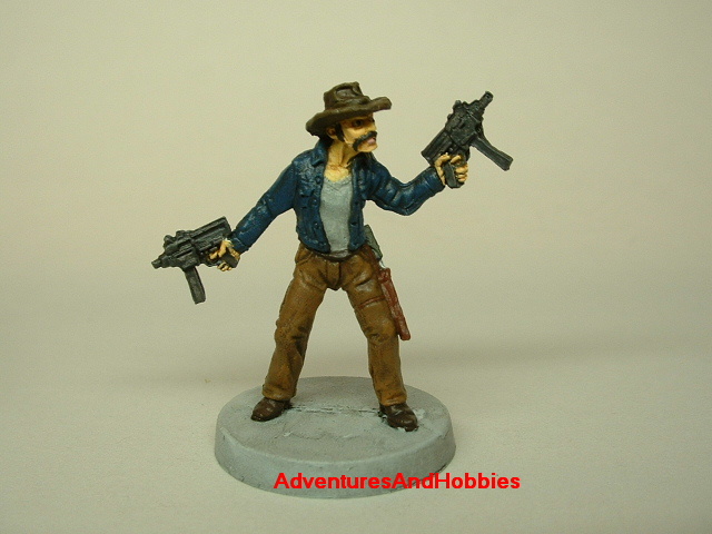 Zombie survivor with sub-machine guns painted figure for role-playing games and table top war games front view