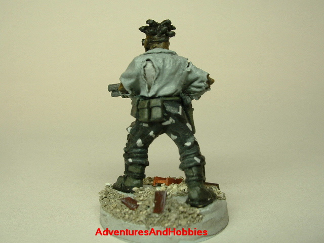 Post apocalypse zombie survivor male civilian warrior painted figure for role-playing games and table top war games rear view.