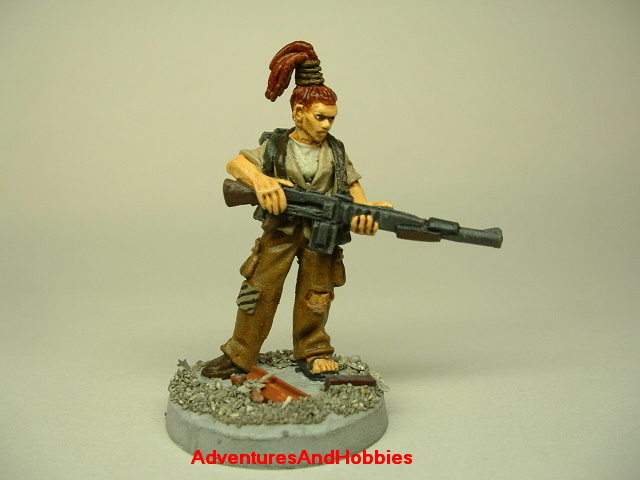 Post apocalypse zombie survivor female warrior painted figure for role-playing games and table top war games front view.