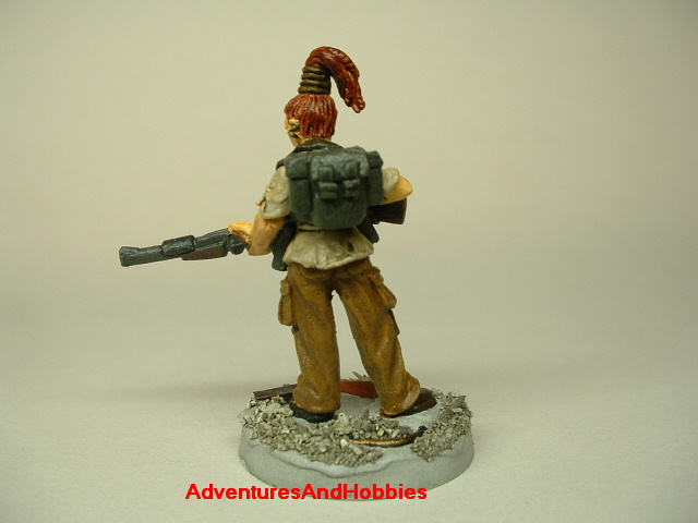 Post apocalypse zombie survivor female warrior painted figure for role-playing games and table top war games rear view.